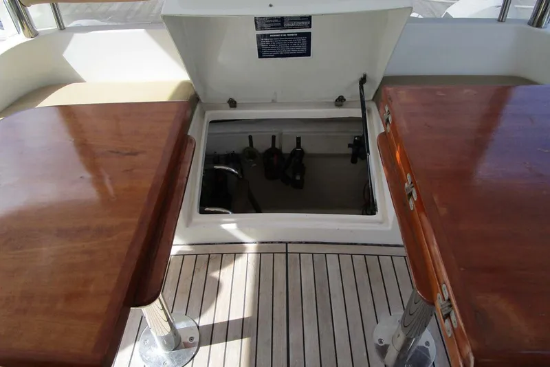 Slide: The Image of Open hatch on 2006 Neptunus 56 Flybridge yacht deck, between wooden tables. - 51