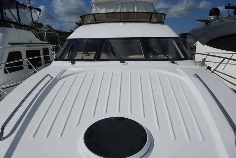 Slide: The Image of 2006 Neptunus 56 Flybridge yacht with sleek white deck and tinted windows. - 38