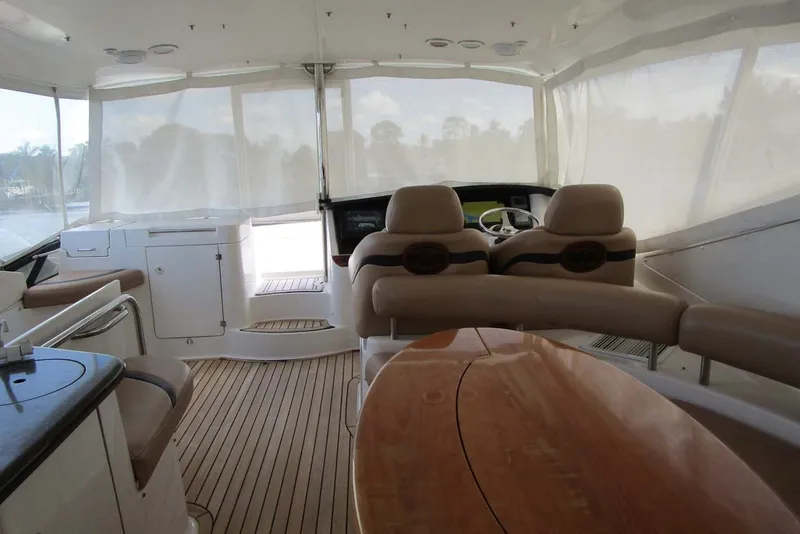 Slide: The Image of Luxurious 2006 Neptunus 56 Flybridge interior with helm, seating, and wooden table. - 67