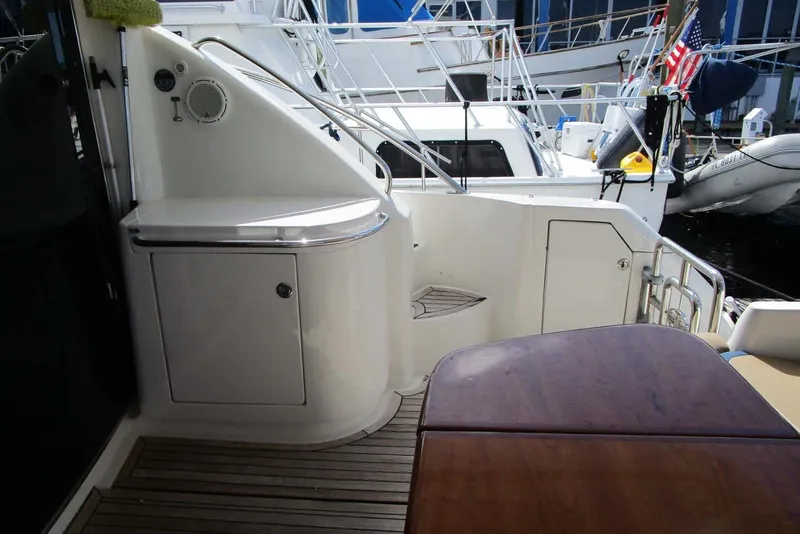 Slide: The Image of 2006 Neptunus 56 Flybridge yacht deck with seating and storage area. - 44