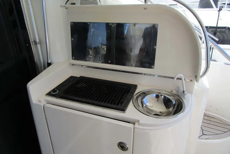 Slide: The Image of Outdoor kitchenette on 2006 Neptunus 56 Flybridge yacht with grill and sink. - 45