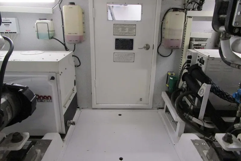 Slide: The Image of Engine room of 2006 Neptunus 56 Flybridge yacht, featuring equipment and control panels. - 79