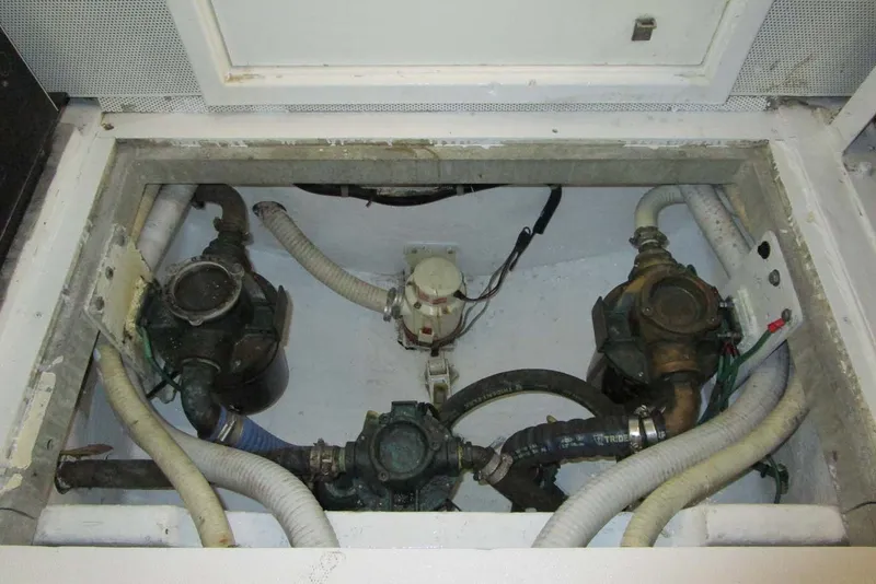 Slide: The Image of Engine compartment of 2006 Neptunus 56 Flybridge with visible hoses and components. - 78