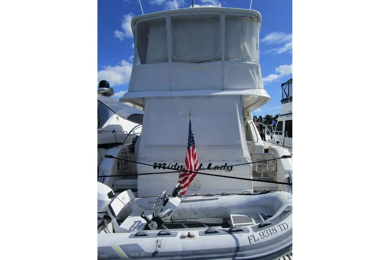 Slide: The Image of 2006 Neptunus 56 Flybridge yacht with American flag and inflatable boat. - 83