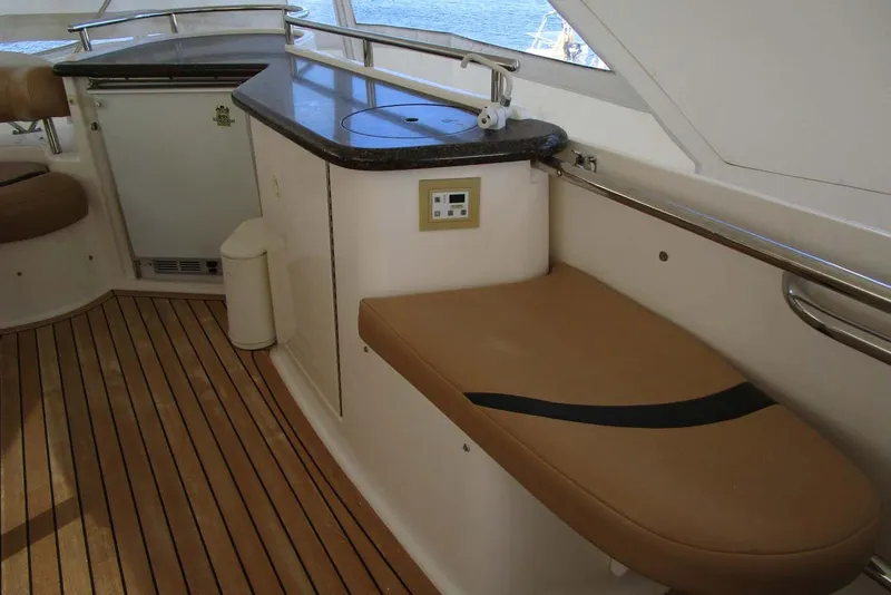 Slide: The Image of Luxurious 2006 Neptunus 56 Flybridge interior with seating and kitchenette area. - 62