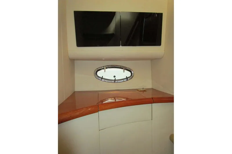 Slide: The Image of Interior of 2006 Neptunus 56 Flybridge yacht with sleek cabinetry and oval window. - 18