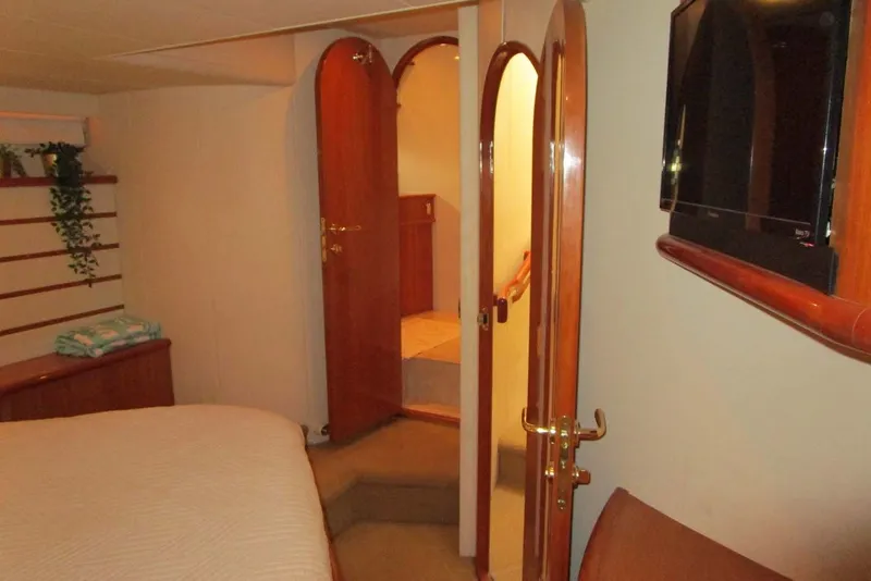 Slide: The Image of Interior of 2006 Neptunus 56 Flybridge yacht with wooden doors and mounted TV. - 22