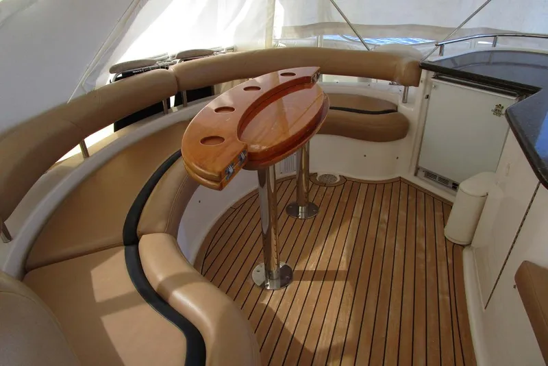 Slide: The Image of Luxurious 2006 Neptunus 56 Flybridge yacht interior with elegant seating and wooden table. - 65
