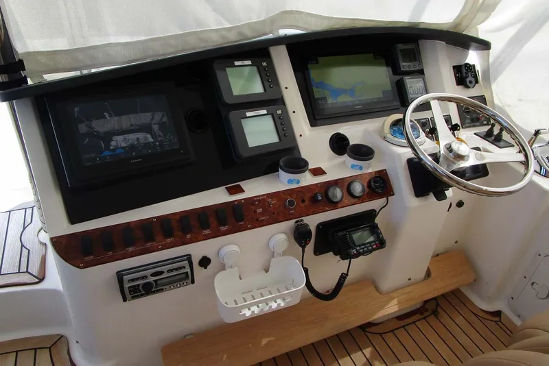 Slide: The Image of Helm of 2006 Neptunus 56 Flybridge yacht with navigation instruments and steering wheel. - 55