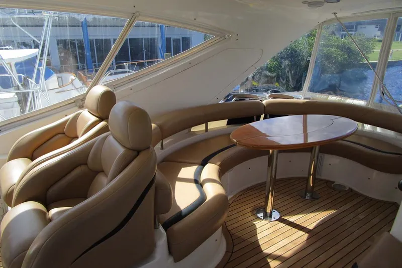 Slide: The Image of Luxurious interior of 2006 Neptunus 56 Flybridge yacht with leather seating and wooden table. - 70