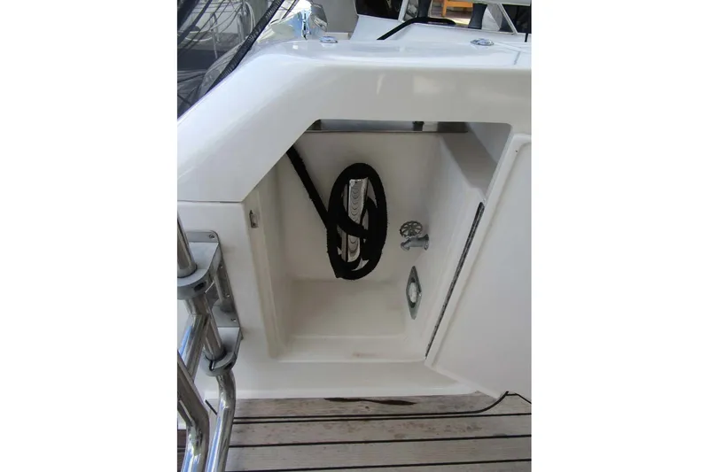 Slide: The Image of Storage compartment on 2006 Neptunus 56 Flybridge yacht, featuring coiled rope and faucet. - 48