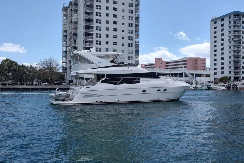 Slide: The Image of 2006 Neptunus 56 Flybridge yacht cruising near waterfront buildings. - 88