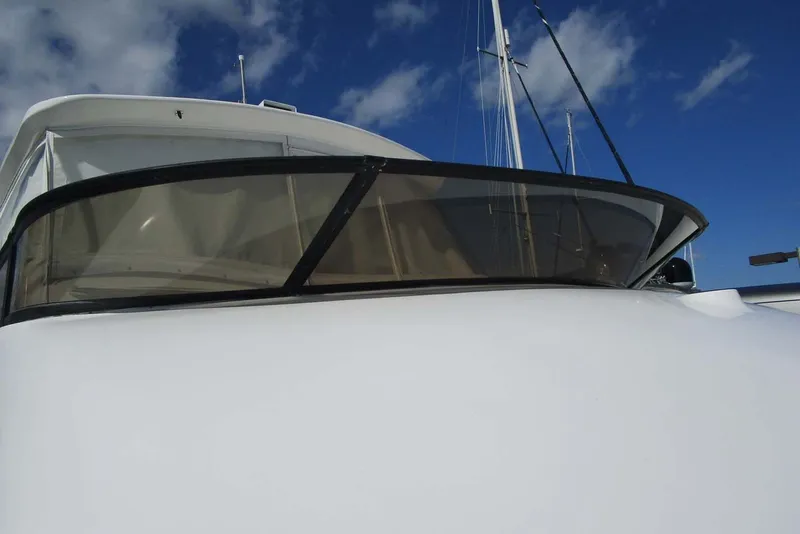 Slide: The Image of 2006 Neptunus 56 Flybridge yacht with sleek design against a blue sky. - 41