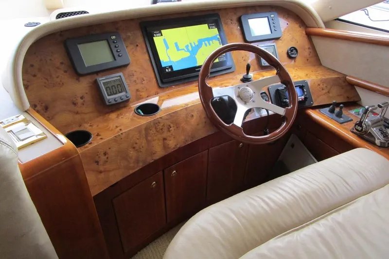 Slide: The Image of Helm of 2006 Neptunus 56 Flybridge yacht with navigation instruments and wooden steering wheel. - 15