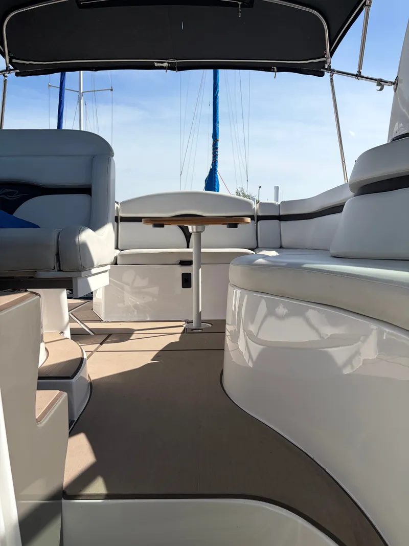 Slide: The Image of Interior of a 2013 Rinker 310 Express with seating area and table. - 9