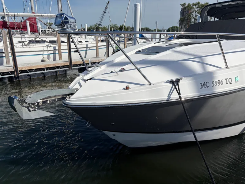 Slide: The Image of The 2013 Rinker 310 Express is docked. It features a sleek, modern design. - 5