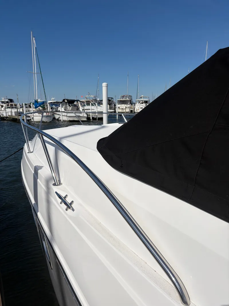 Slide: The Image of 2013 Rinker 310 Express docked, showing the deck and railing clearly. - 6