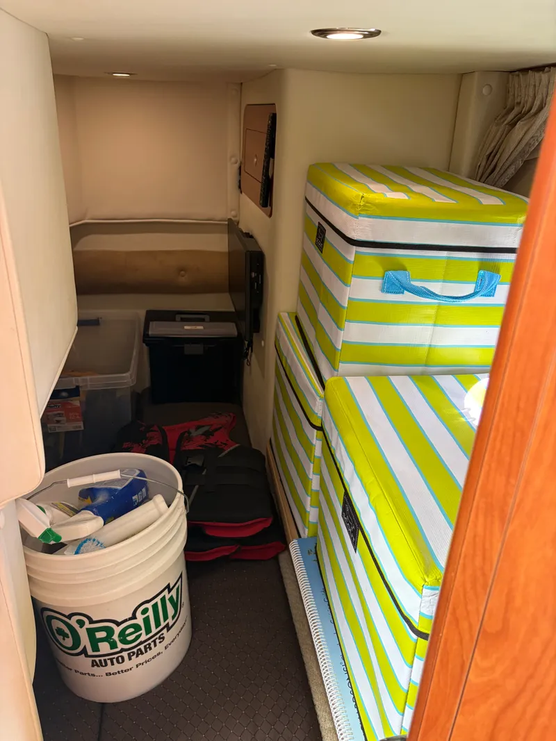 Slide: The Image of Interior with stacked striped cushions and a bucket of cleaning supplies. - 10