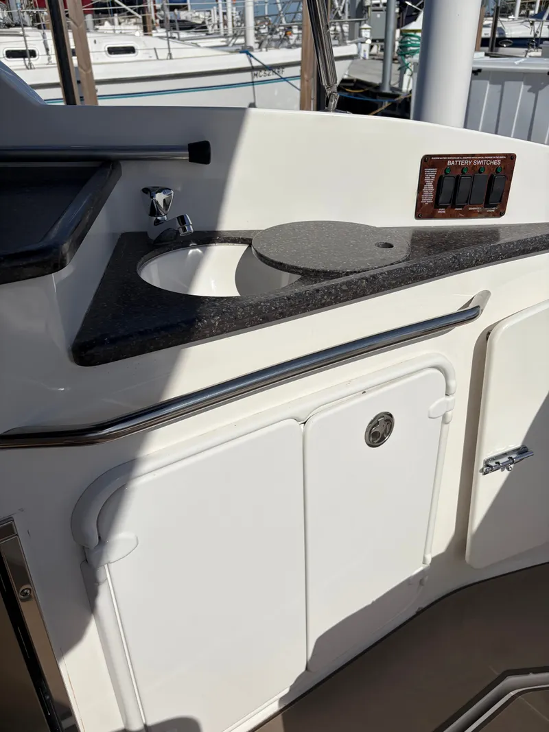 Slide: The Image of The galley area on a 2013 Rinker 310 Express with a sink and countertop. - 20