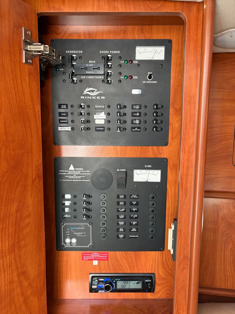 Slide: The Image of Electrical control panel in a Rinker 310 Express boat, featuring various switches and indicators. - 12