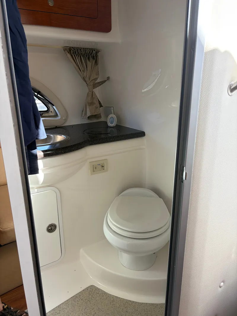 Slide: The Image of The image shows a boat bathroom with a toilet and a sink. - 7