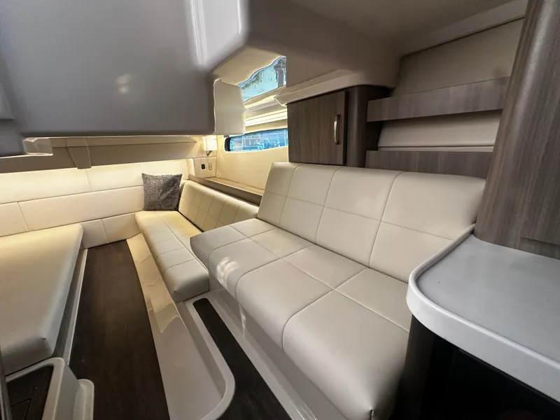 Slide: The Image of Interior of the 2021 Regal 36 Grande Coupe with sleek cream upholstery and modern wood paneling. - 10