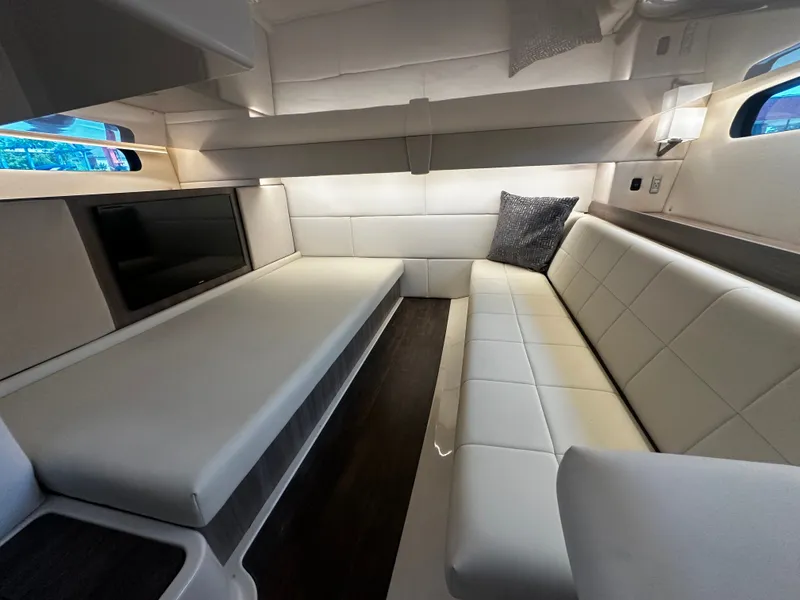 Slide: The Image of Interior of the 2021 Regal 36 Grande Coupe with white upholstery and a TV. - 8