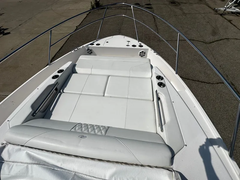Slide: The Image of The image shows the bow of a 2021 Regal 36 Grande Coupe with white cushions. - 5