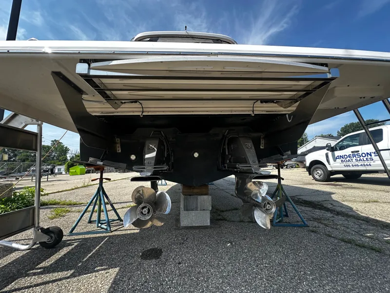 Slide: The Image of Rear view of a 2021 Regal 36 Grande Coupe with dual propellers on stands. - 3