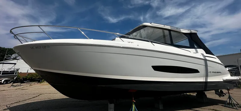 Slide: The Image of 2021 Regal 36 Grande Coupe on dry dock, featuring sleek design and enclosed cabin. - 20
