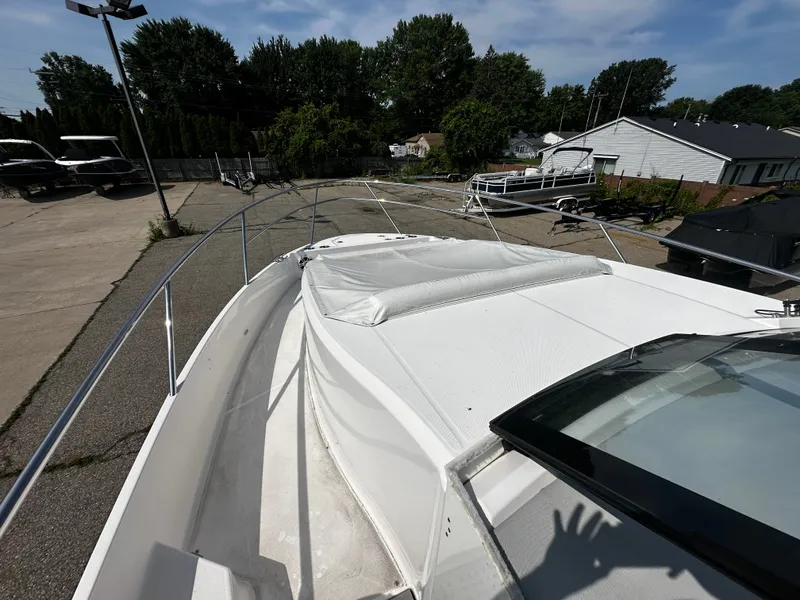 Slide: The Image of The deck of a 2021 Regal 36 Grande Coupe, parked in a lot with other boats. - 6