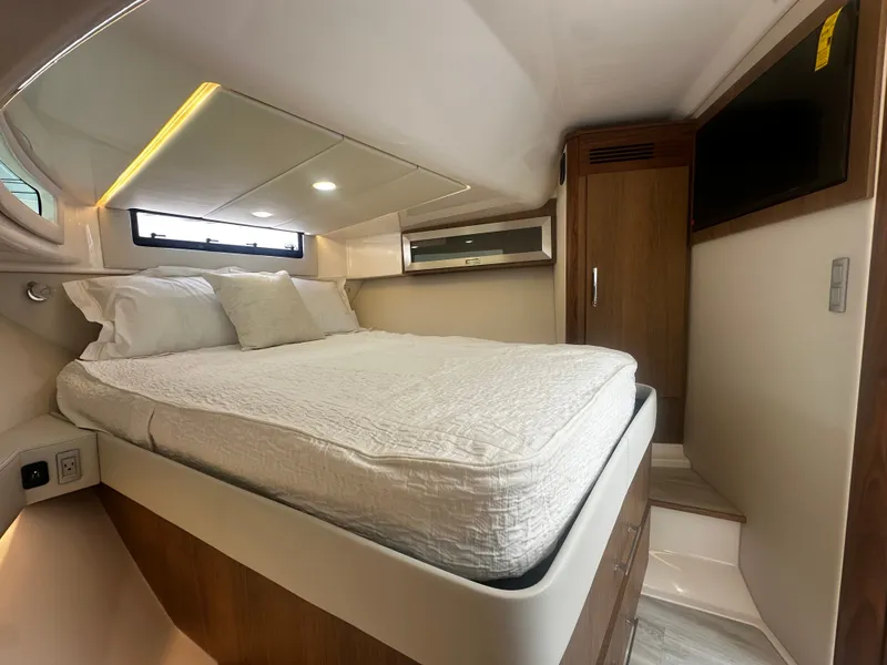 Slide: The Image of The image shows a luxurious cabin with a large bed, wooden furniture, and a window. - 27