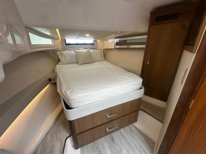 Slide: The Image of The image shows a cozy cabin with a double bed, wooden furniture, and a small window. - 23