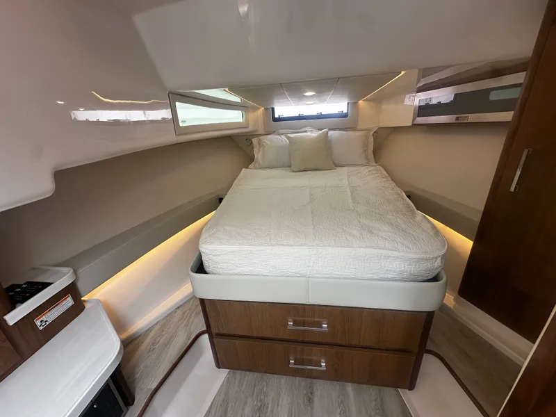 Slide: The Image of The interior of a 2027 Regal 36 Grande Coupe features a cozy bedroom with a large bed. - 25