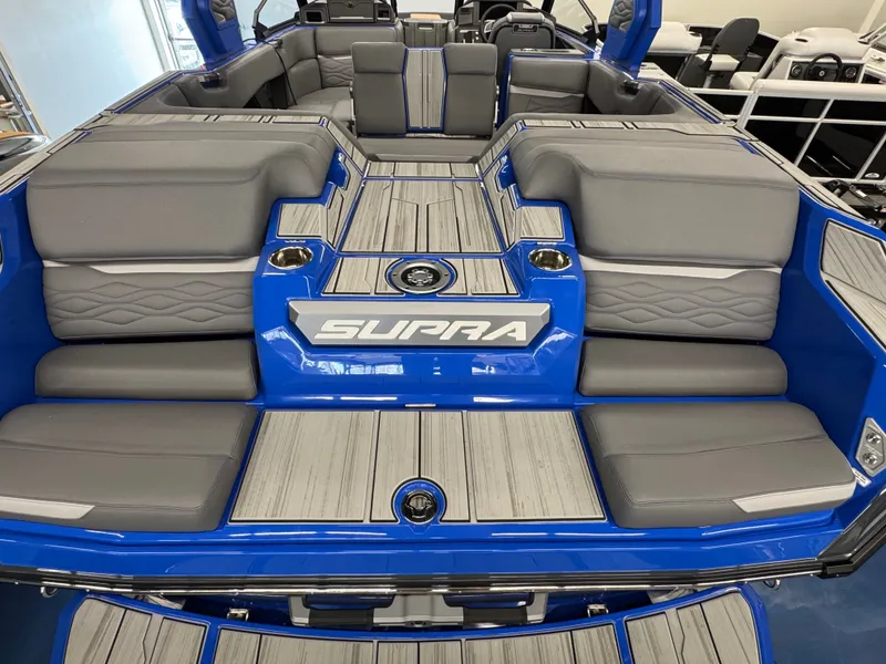 Slide: The Image of The image shows the interior of a 2025 Supra SA 450 boat with gray upholstery. - 13