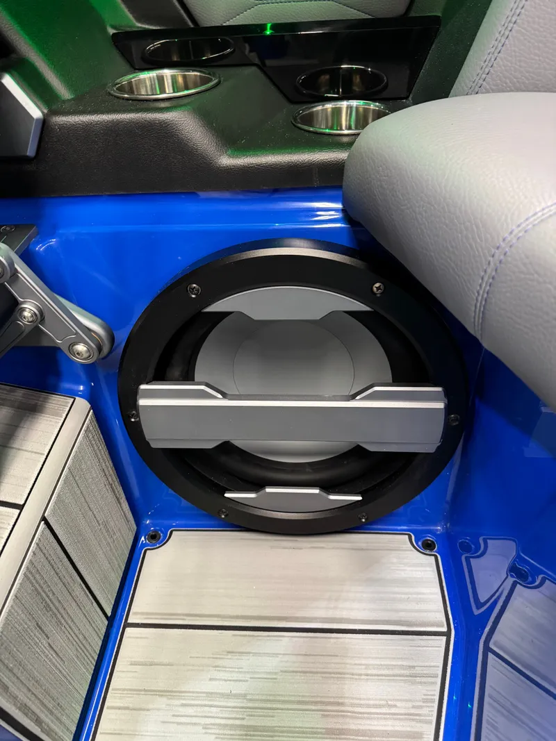Slide: The Image of A speaker is integrated into the blue interior panel of a boat, surrounded by gray upholstery. - 25