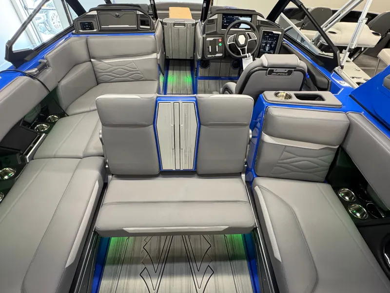 Slide: The Image of The image shows the interior of a 2025 Supra SA 450 boat with gray seats and blue accents. - 16