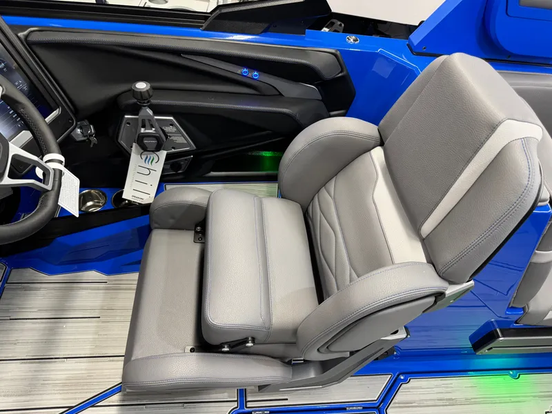 Slide: The Image of Gray captain's seat in a blue boat with modern dashboard and controls. - 28
