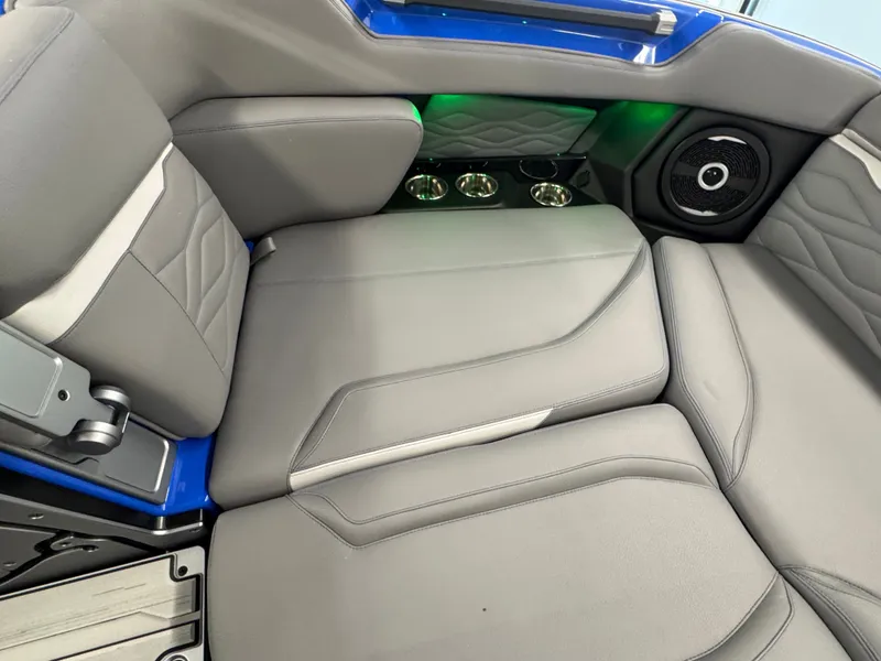 Slide: The Image of The image shows the gray upholstered seats of a Supra SA 450 boat with green lighting and a speaker. - 20