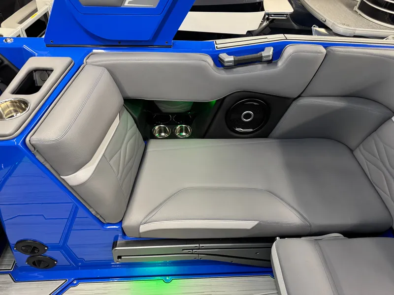 Slide: The Image of The image shows a gray seat in a blue boat with speakers and cup holders. - 23