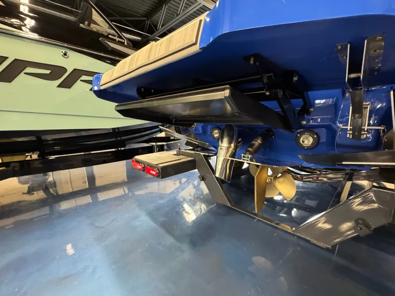 Slide: The Image of The image shows the rear of a blue boat with propeller and rudder system. - 8