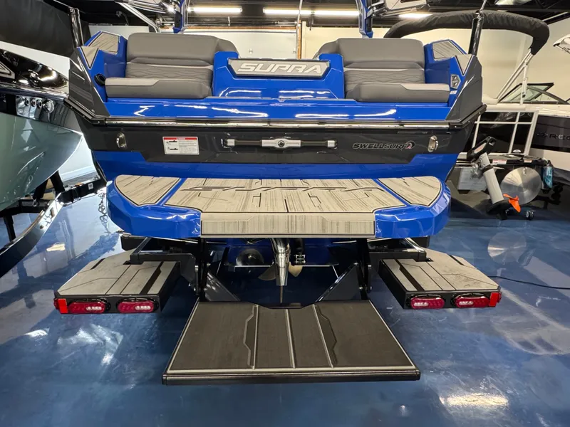 Slide: The Image of The image shows the rear of a blue Supra SA 450 boat with gray seating. - 7