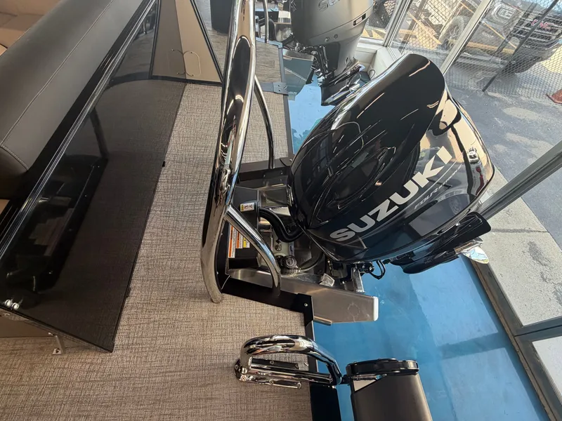 Slide: The Image of A Suzuki outboard motor is mounted on a boat, which is on a blue floor. - 13