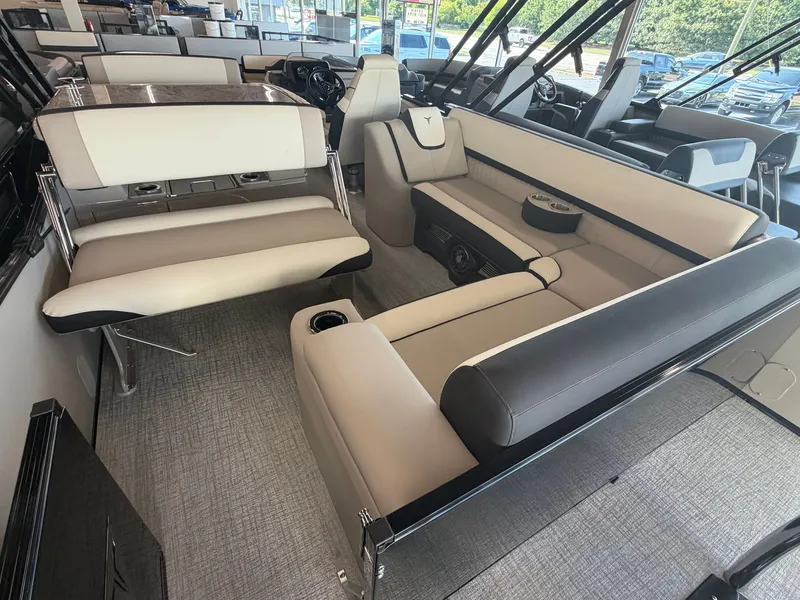 Slide: The Image of Interior of a modern pontoon boat with sleek seating and table, surrounded by large windows. - 14