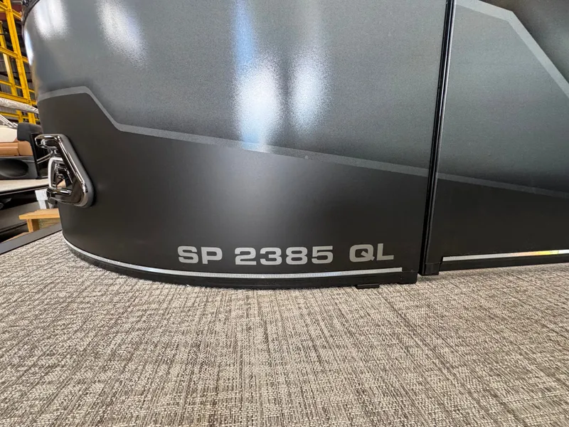 Slide: The Image of Close-up of a Tahoe Sport 85 QL boat with sleek gray exterior. - 2