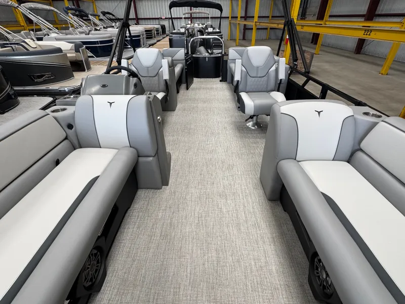 Slide: The Image of Interior of a modern pontoon boat with gray and white seating in a warehouse. - 10