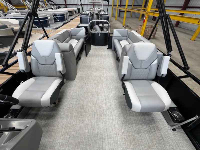 Slide: The Image of Interior of a modern pontoon boat with gray and white seats, spacious layout, and sleek details. - 9