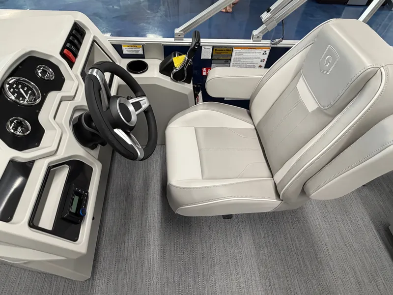 Slide: The Image of The image shows the helm of a 2027 Godfrey EX 1880 Cruise with a sleek steering wheel and comfortable seat. - 10