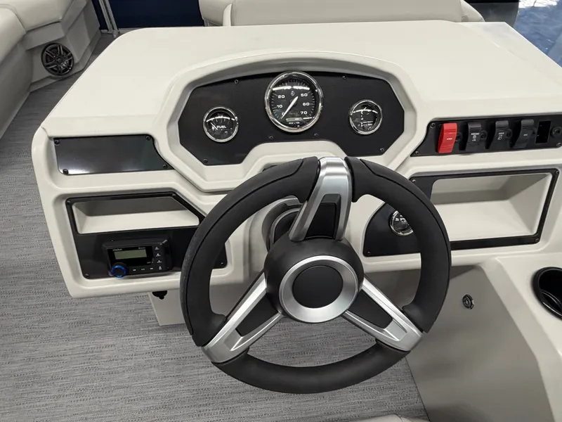 Slide: The Image of The image shows a boat's helm with a modern steering wheel and instruments. - 7