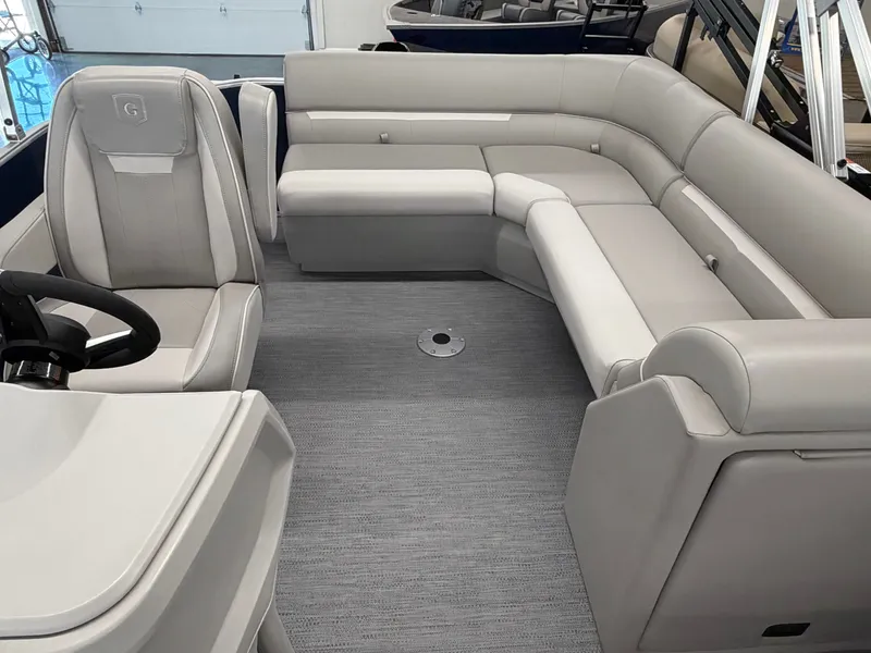 Slide: The Image of Interior of a modern pontoon boat with gray upholstered seating and a helm station. - 4